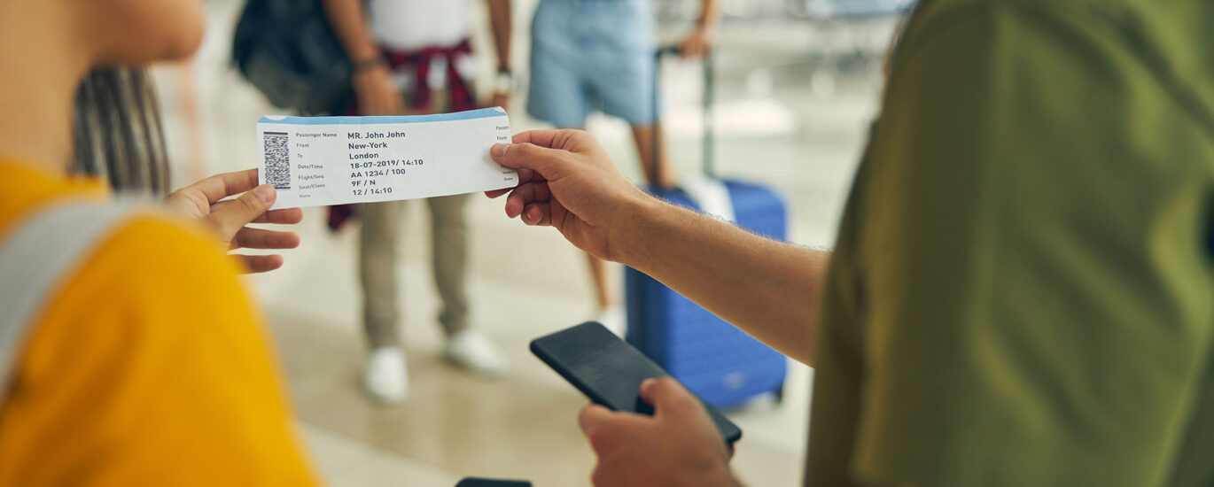 Man asking female about his boarding ticket