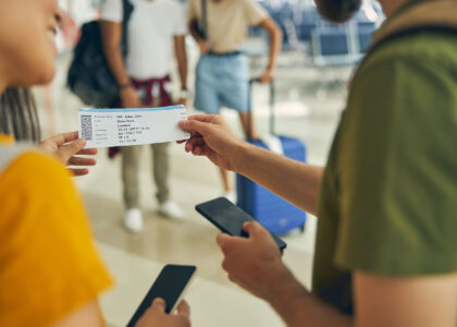 Man asking female about his boarding ticket