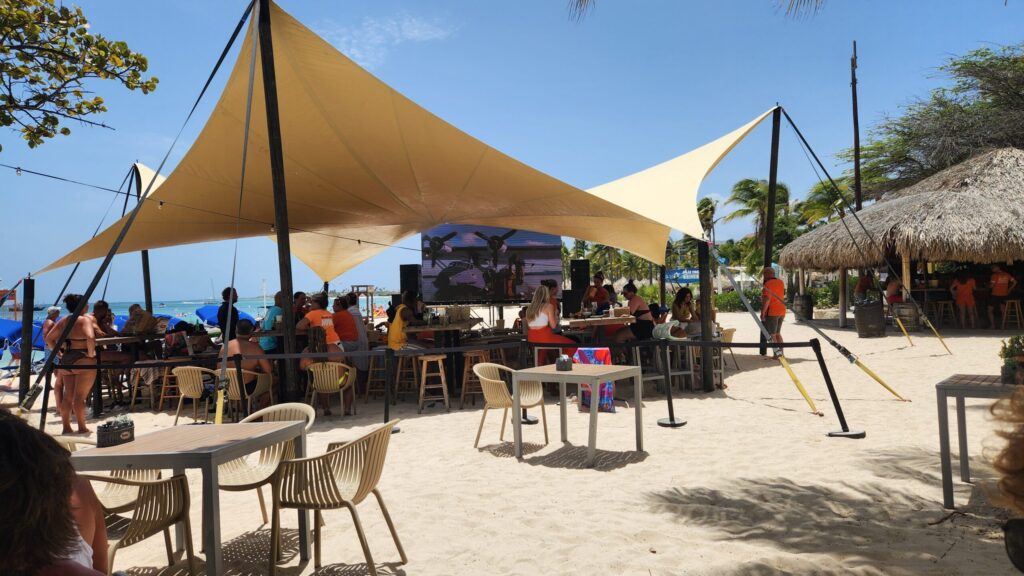 A lively soccer viewing experience at MooMba Bar in Aruba with fans enjoying UEFA Euro 2024 matches.